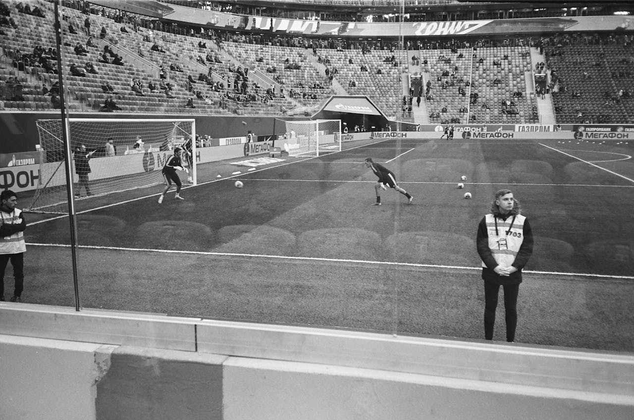Grayscale Photo of Men Playing Soccer